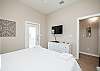 Master bedroom with king size bed, access to private patio and flat screen TV