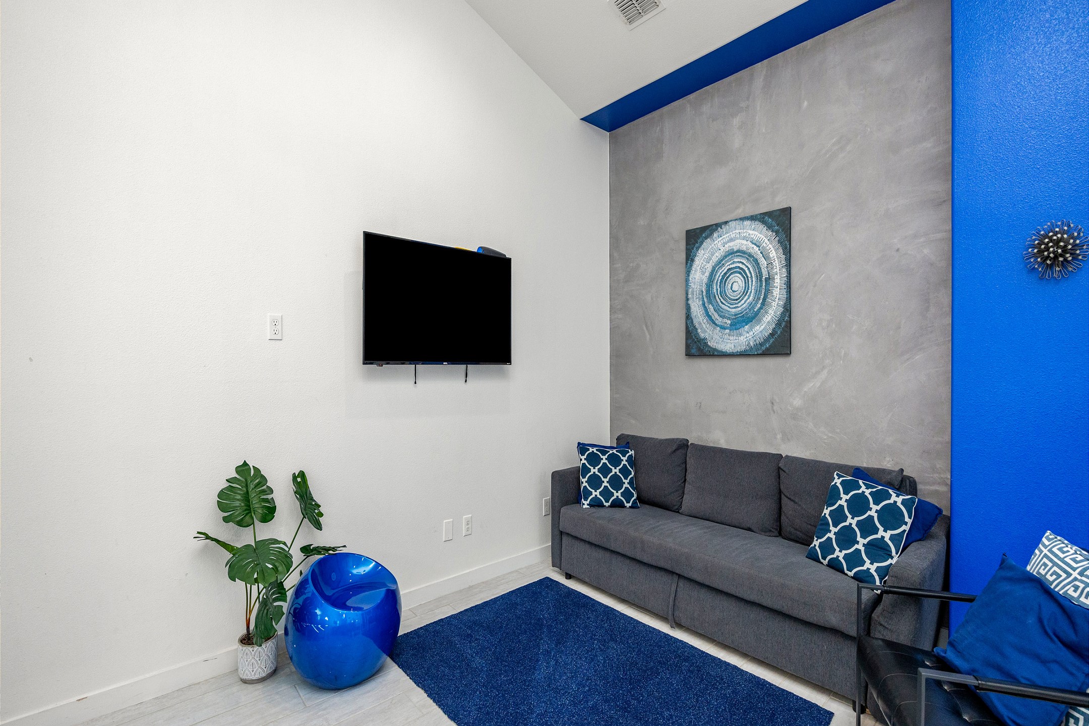 Living area with queen size sleeper sofa, modern furniture, and flat screen TV
