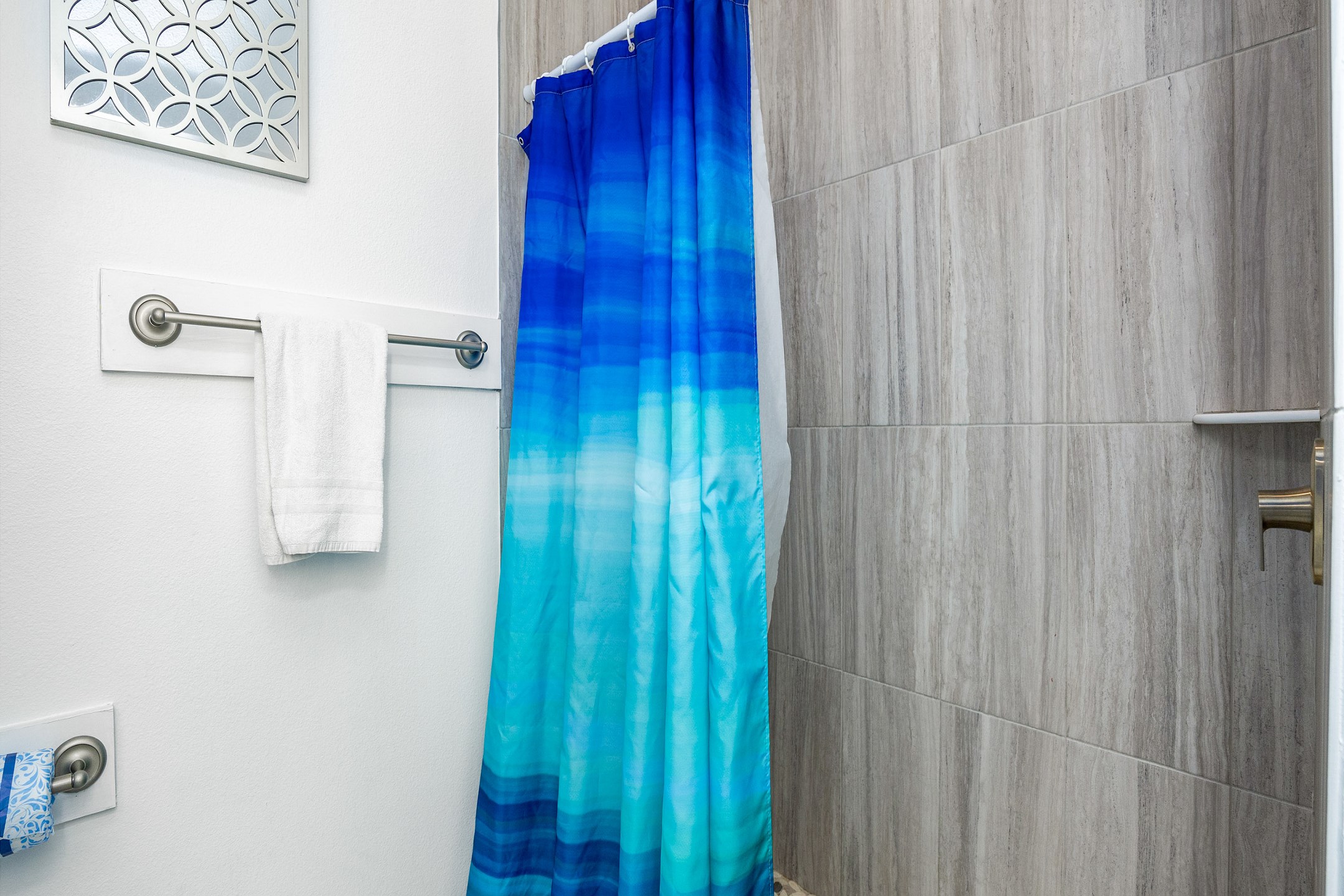 Guest bathroom with single sink and walk in shower