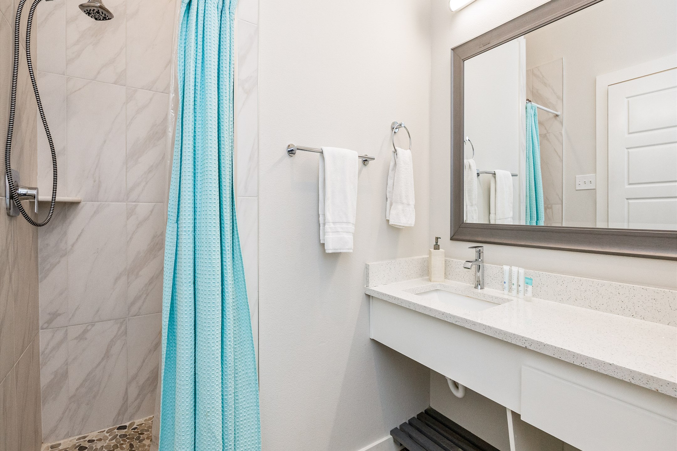 Full bathroom with single sink, toilet, and walk-in shower