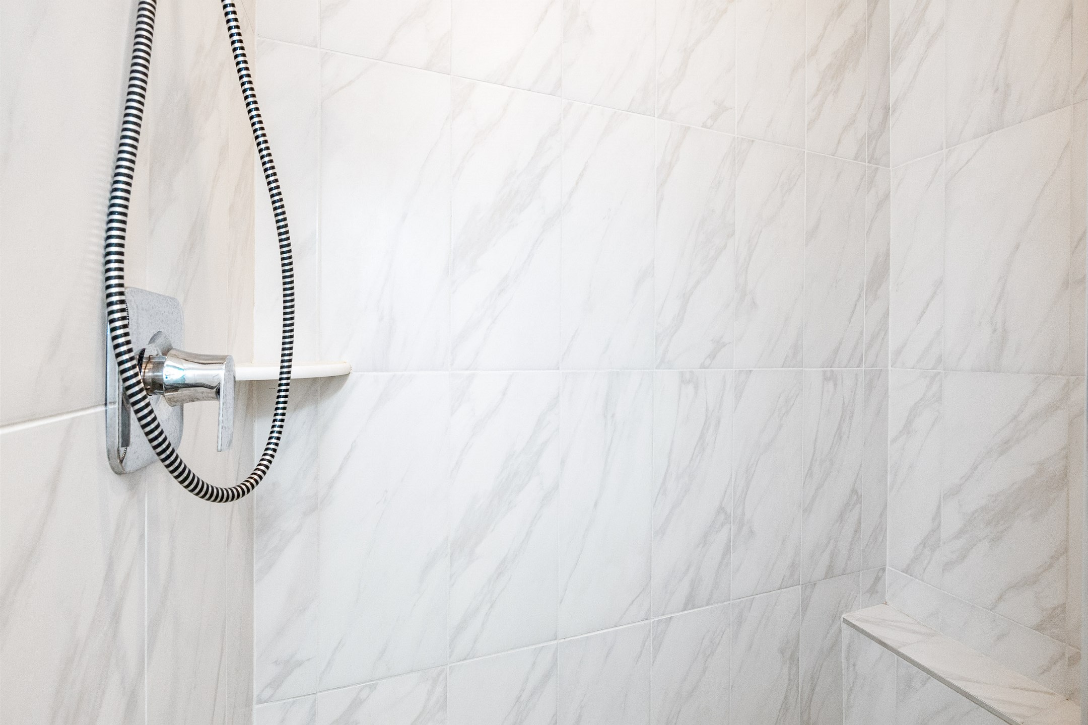 Full bathroom with single sink, toilet, and walk-in shower