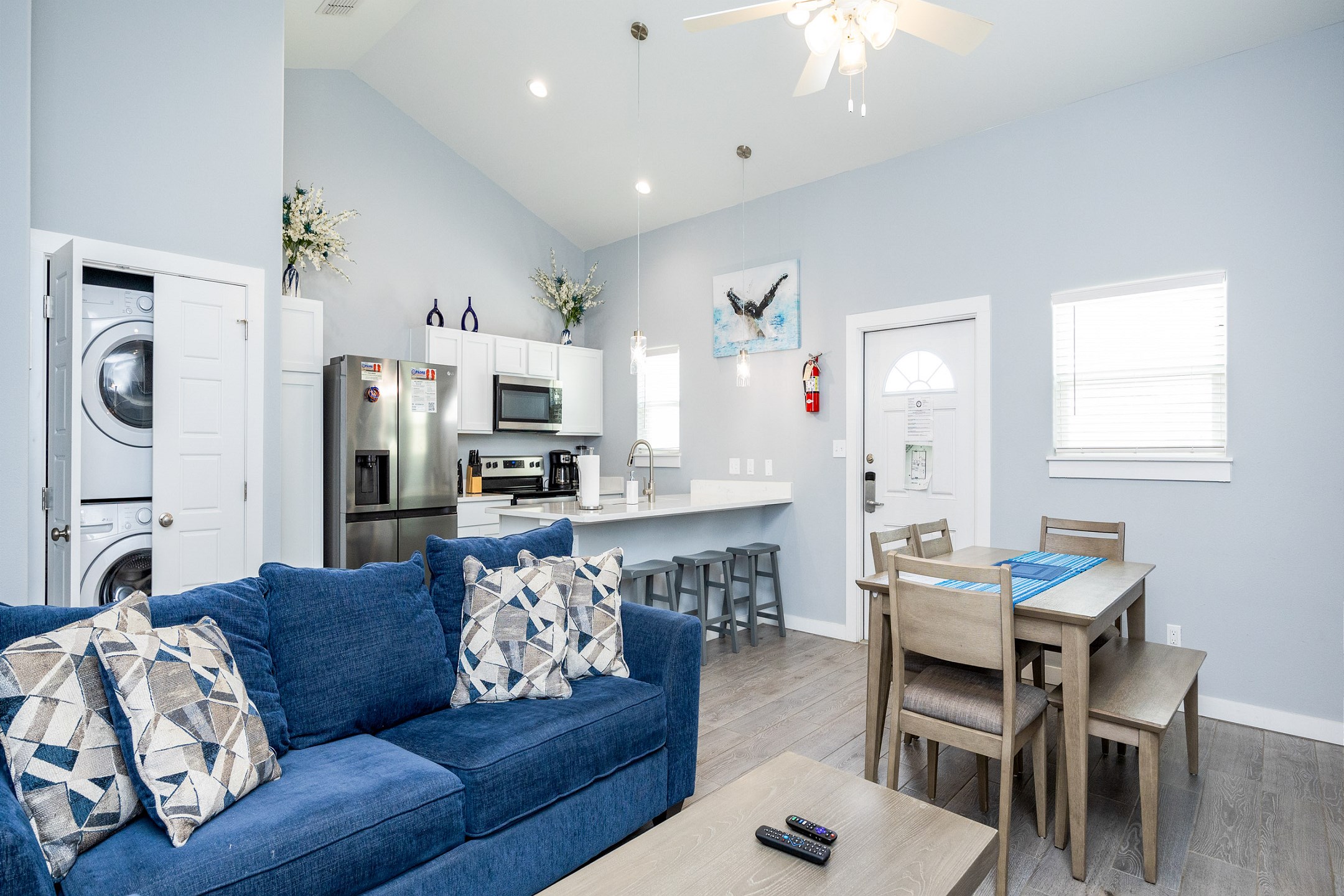 Open concept living area with queen size sofa sleeper and flat screen TV 