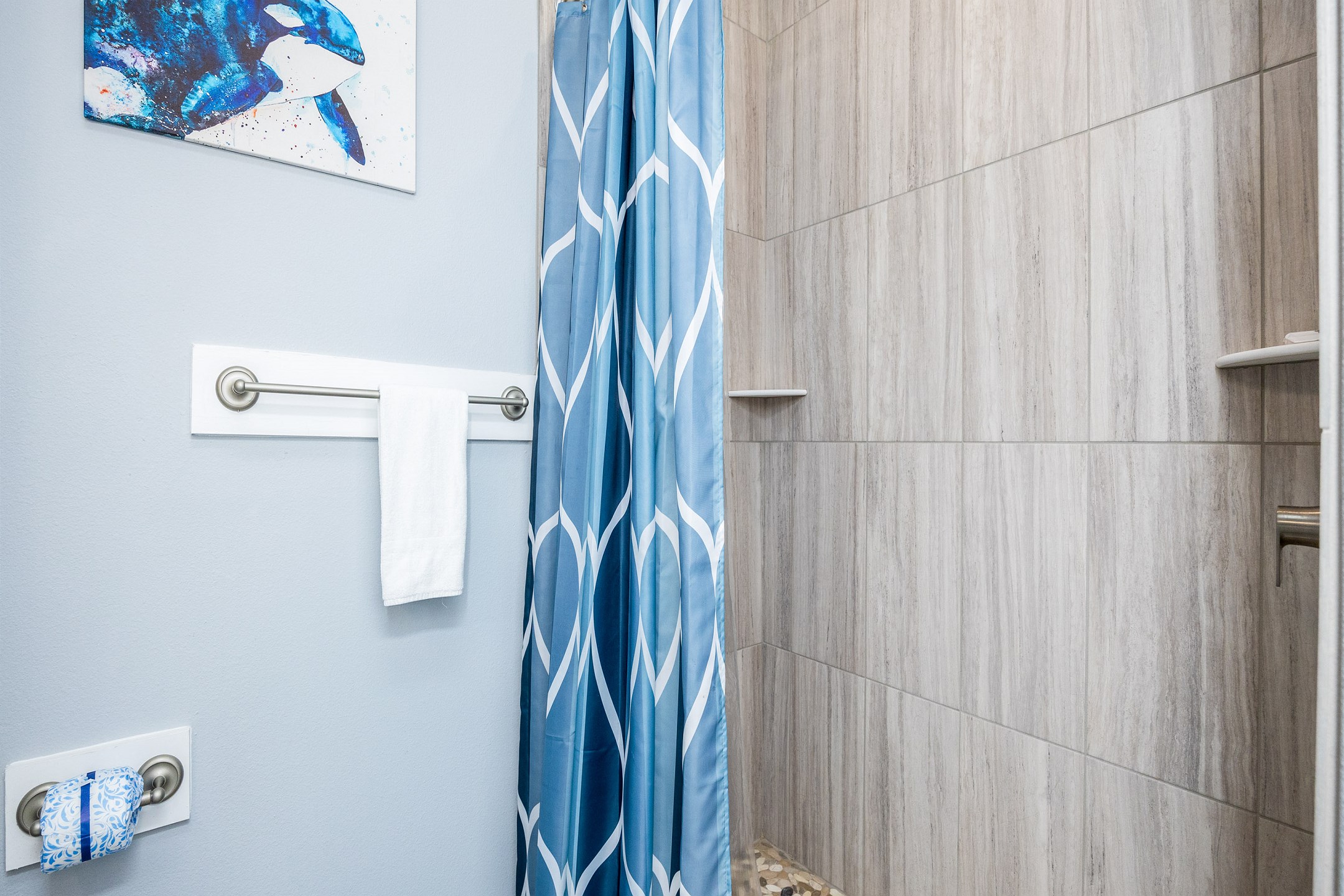 Guest bathroom with single sink and walk in shower 