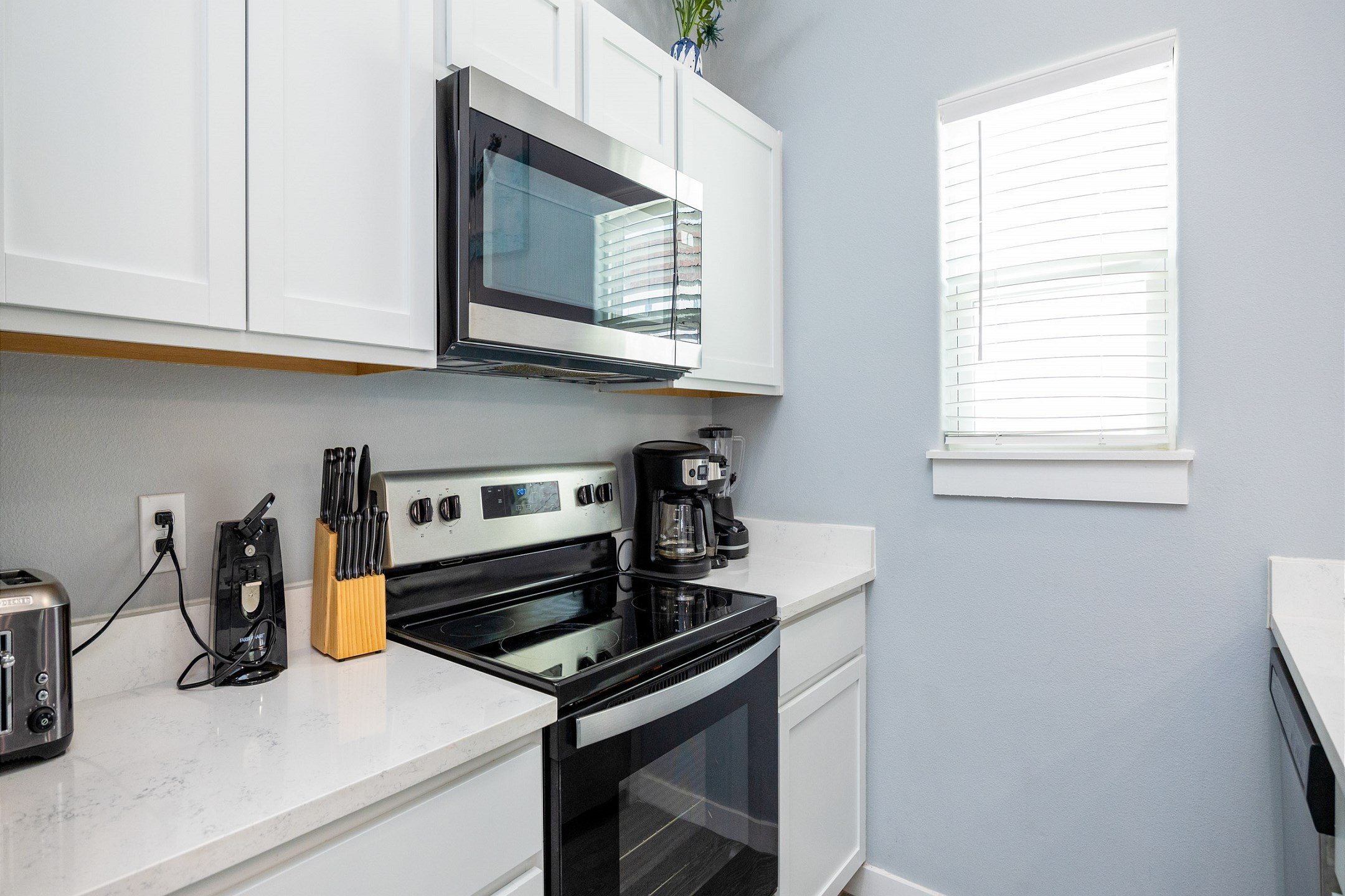 Bright kitchen area with beautiful white granite counter tops 