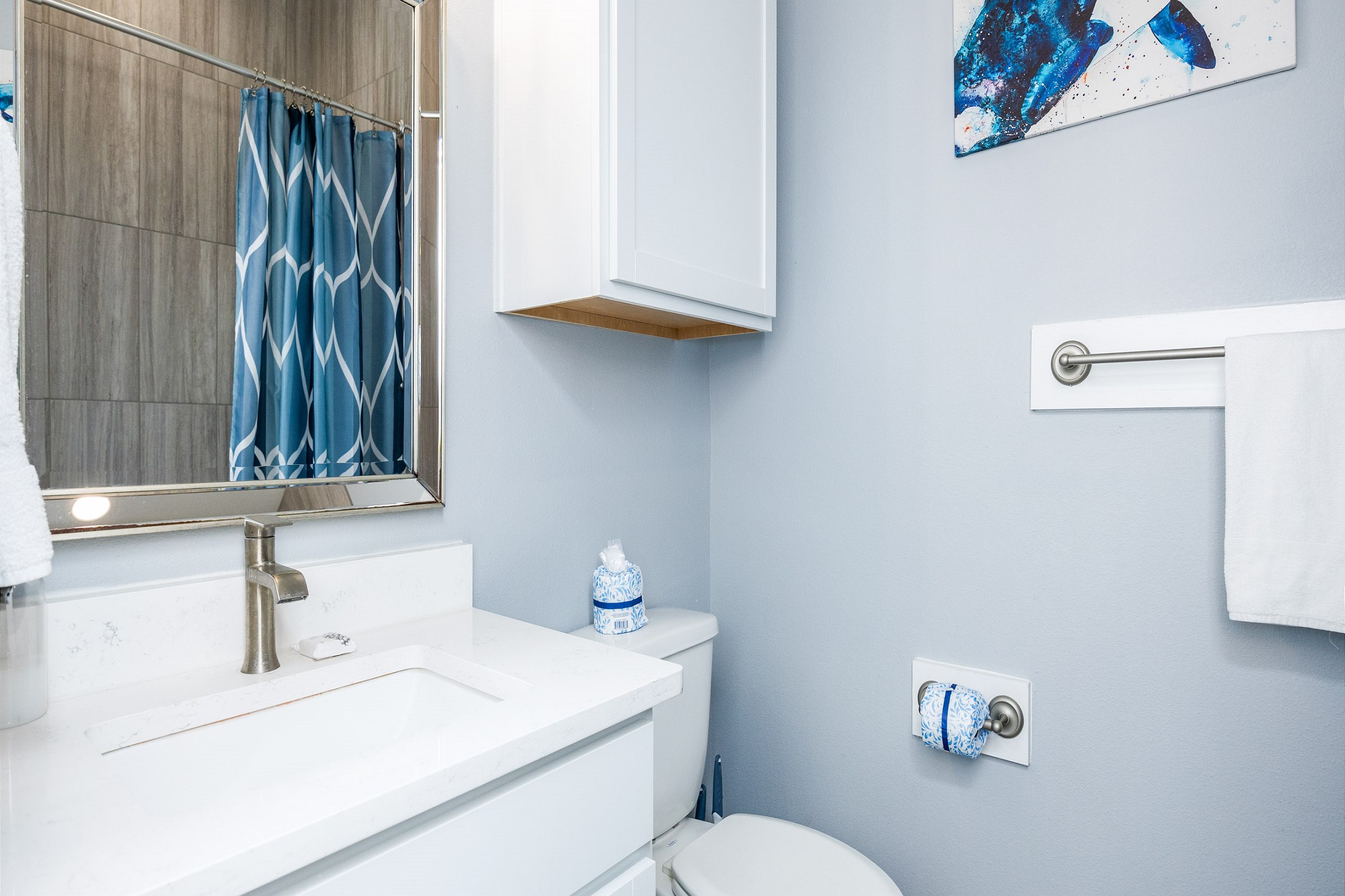 Guest bathroom with single sink and walk in shower 