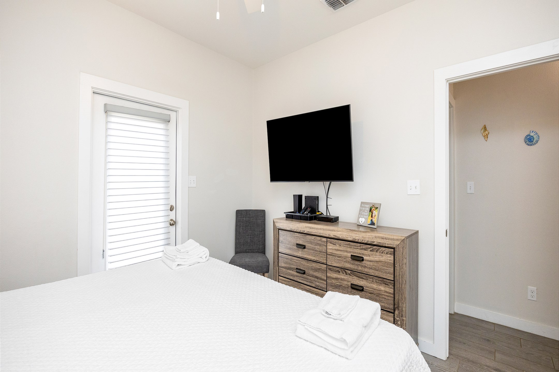 Master bedroom with king size bed, back patio access, and flat screen TV 