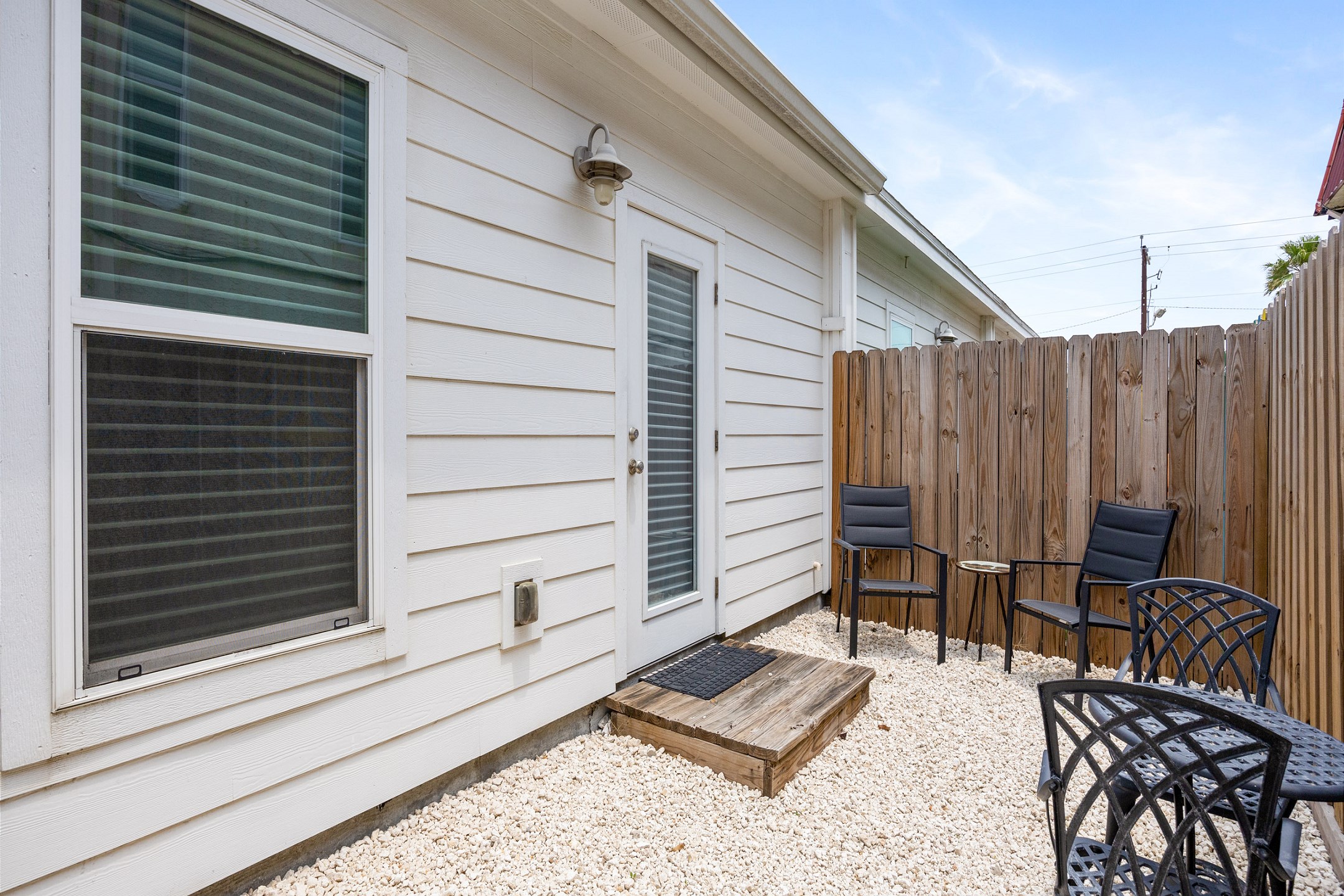 Enjoy the Texas breeze on this private patio with seating 