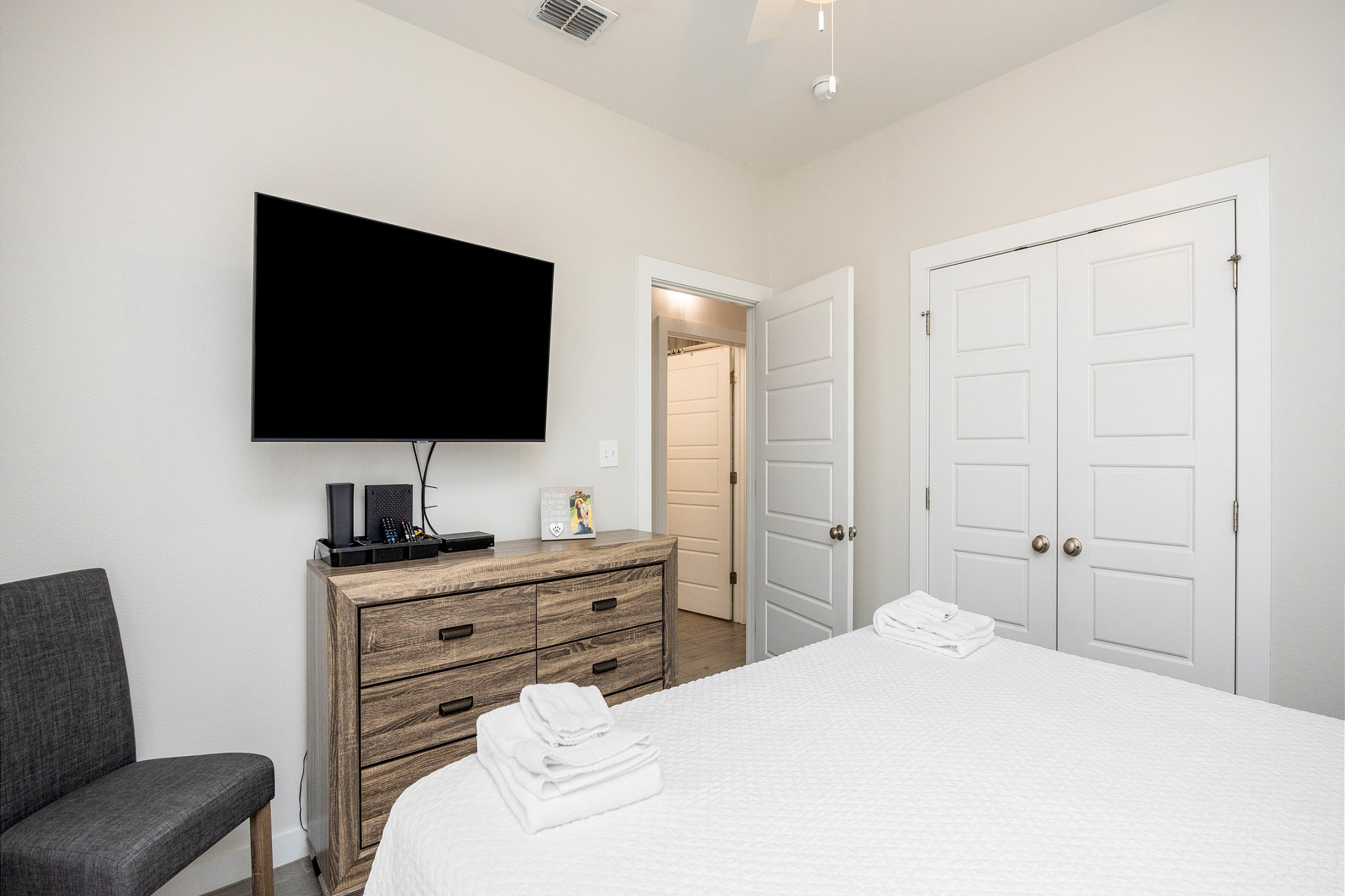 Master bedroom with king size bed, back patio access, and flat screen TV 