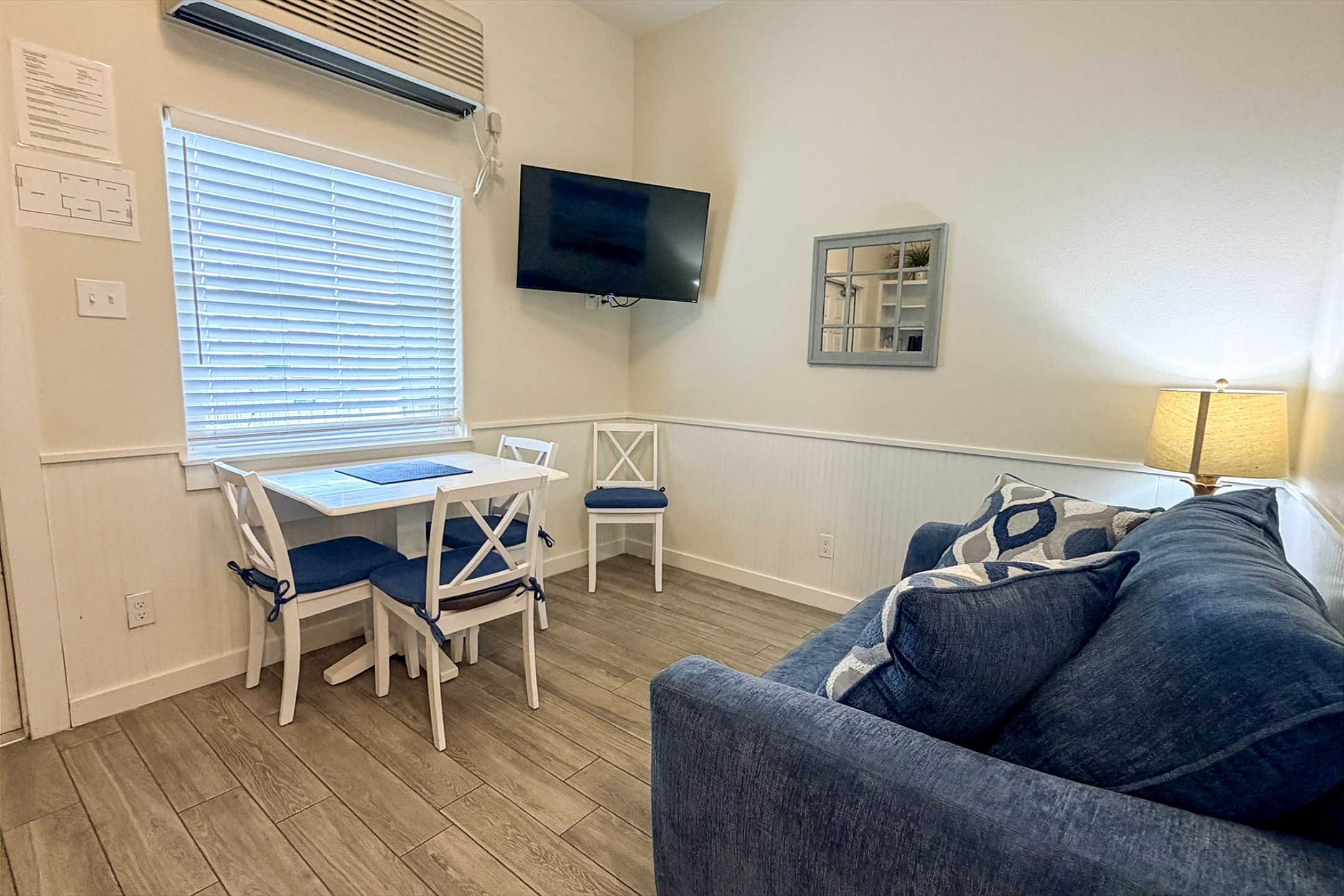 Cozy living area with dining and flat screen TV, only steps to the sparkling pool