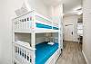 Twin size bunk beds and washer/dryer in hallway nook