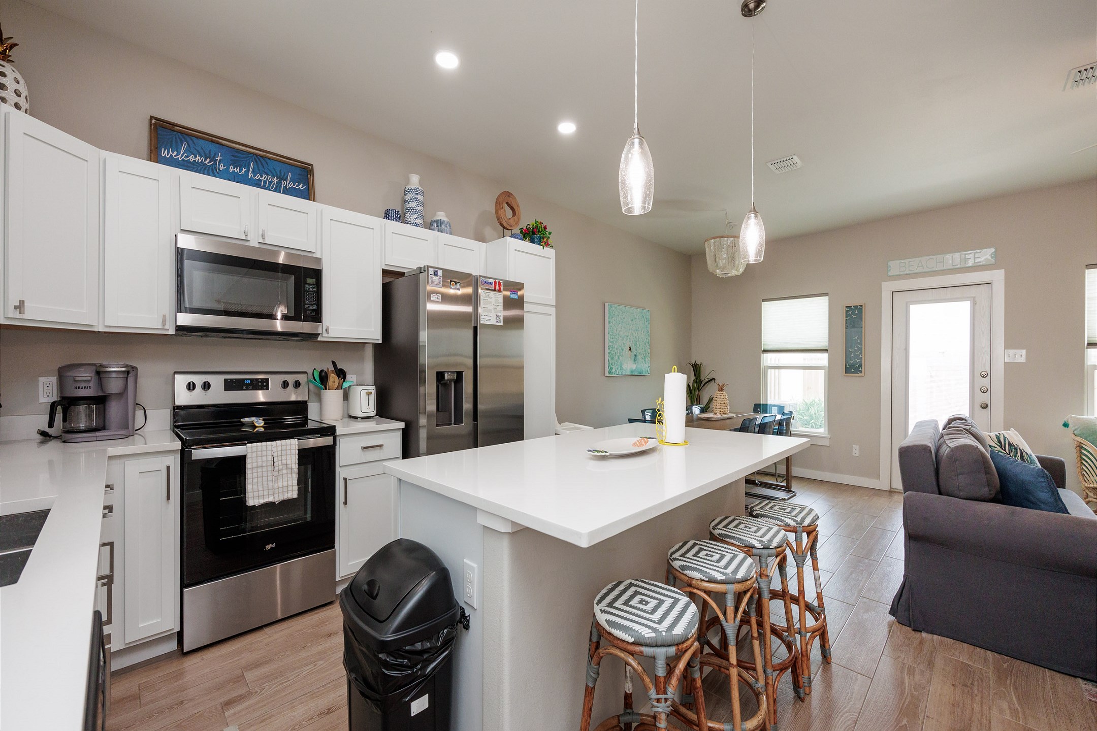 Fully equipped kitchen with stainless steel appliances and breakfast bar that seats four 