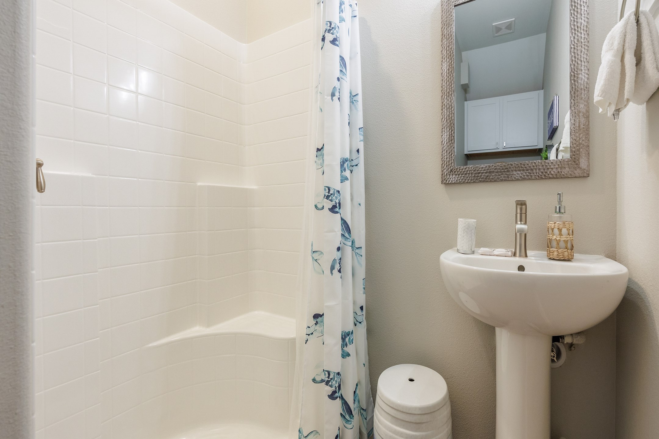 Guest bathroom on the first floor with single sink, toilet and walk in shower