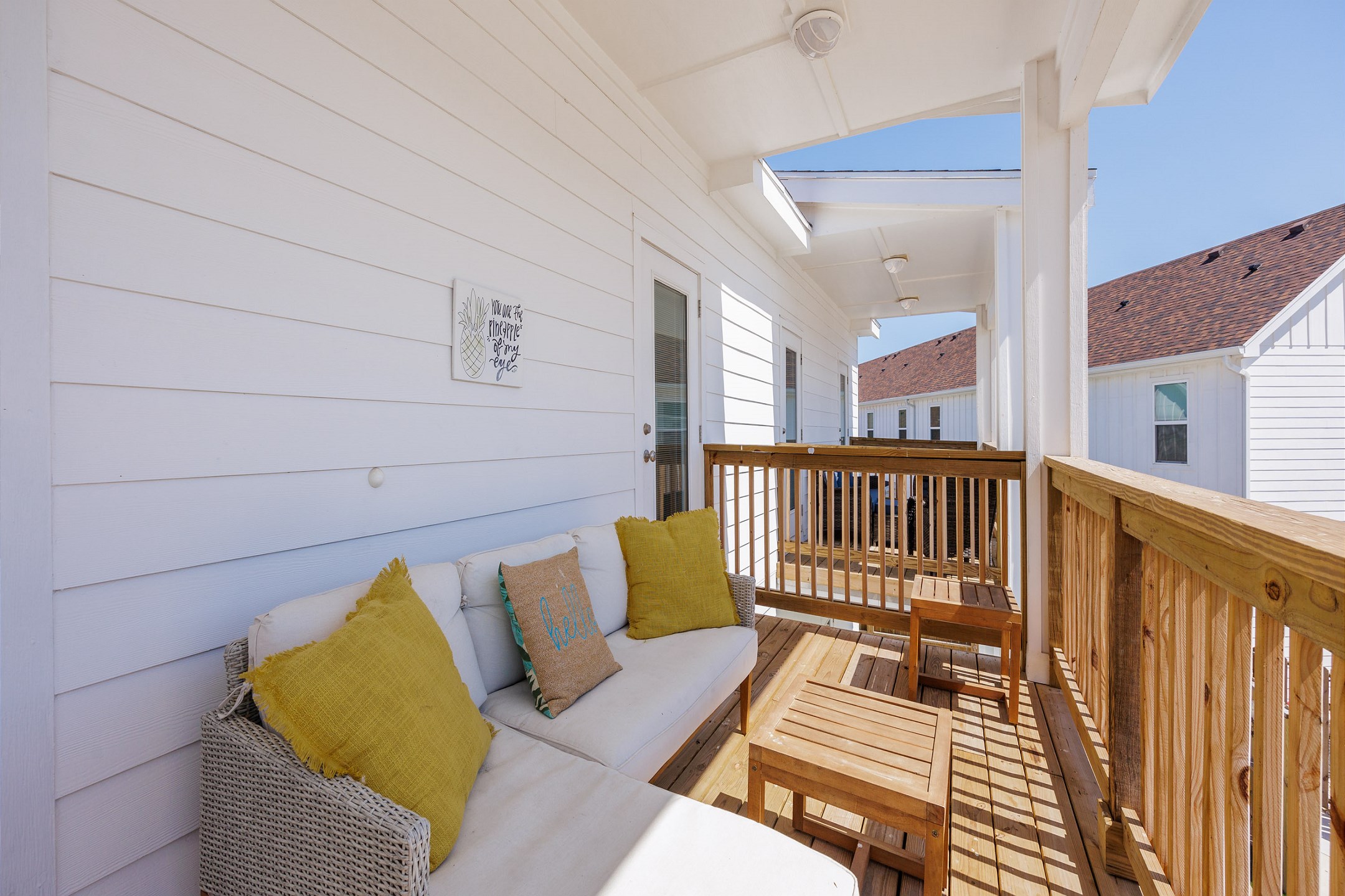 Shared balcony off the bedrooms with cozy seating that over looks the pool and canal 