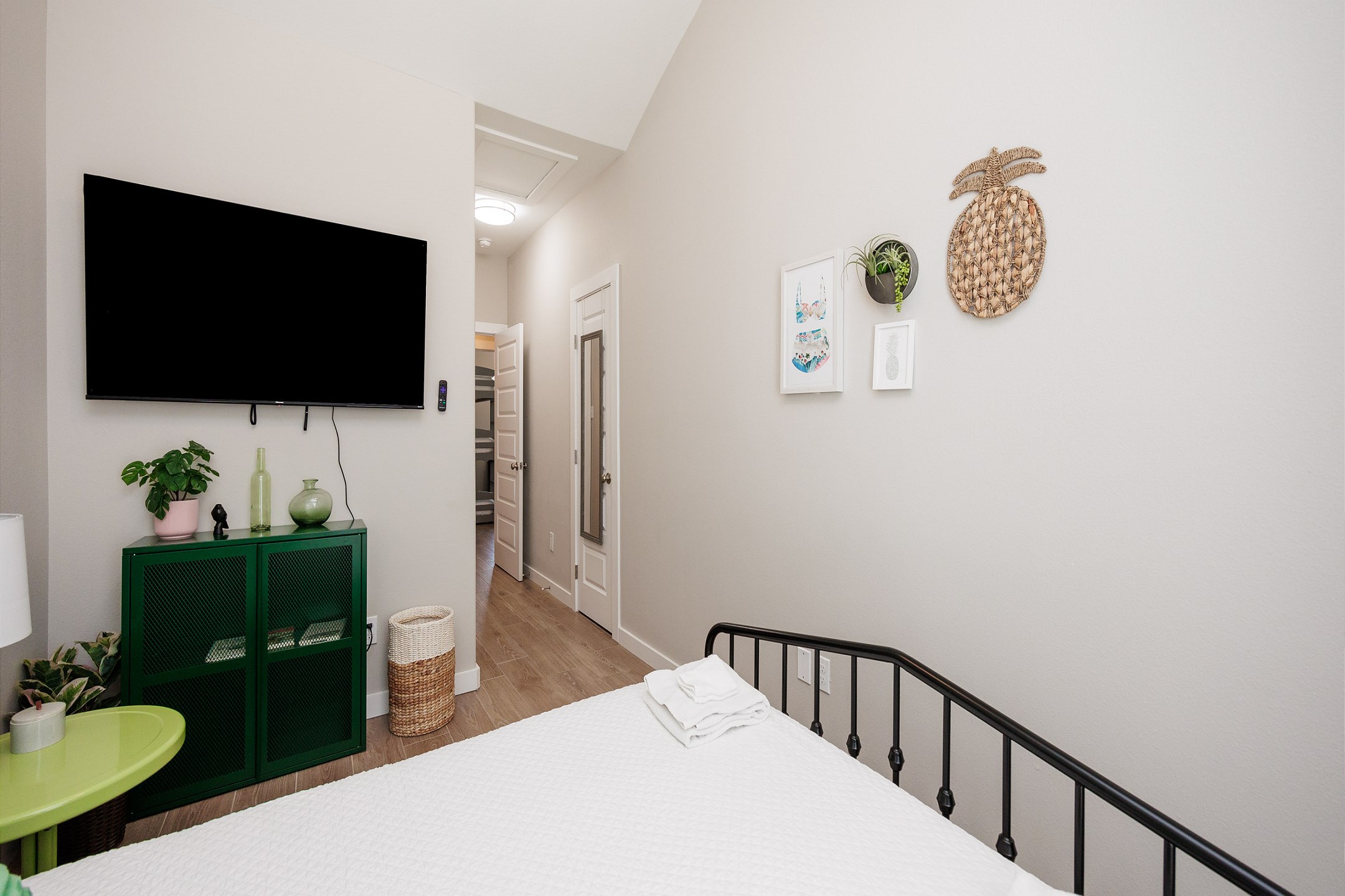 Second bedroom on the second floor with queen size bed, shared balcony access and flat screen TV 