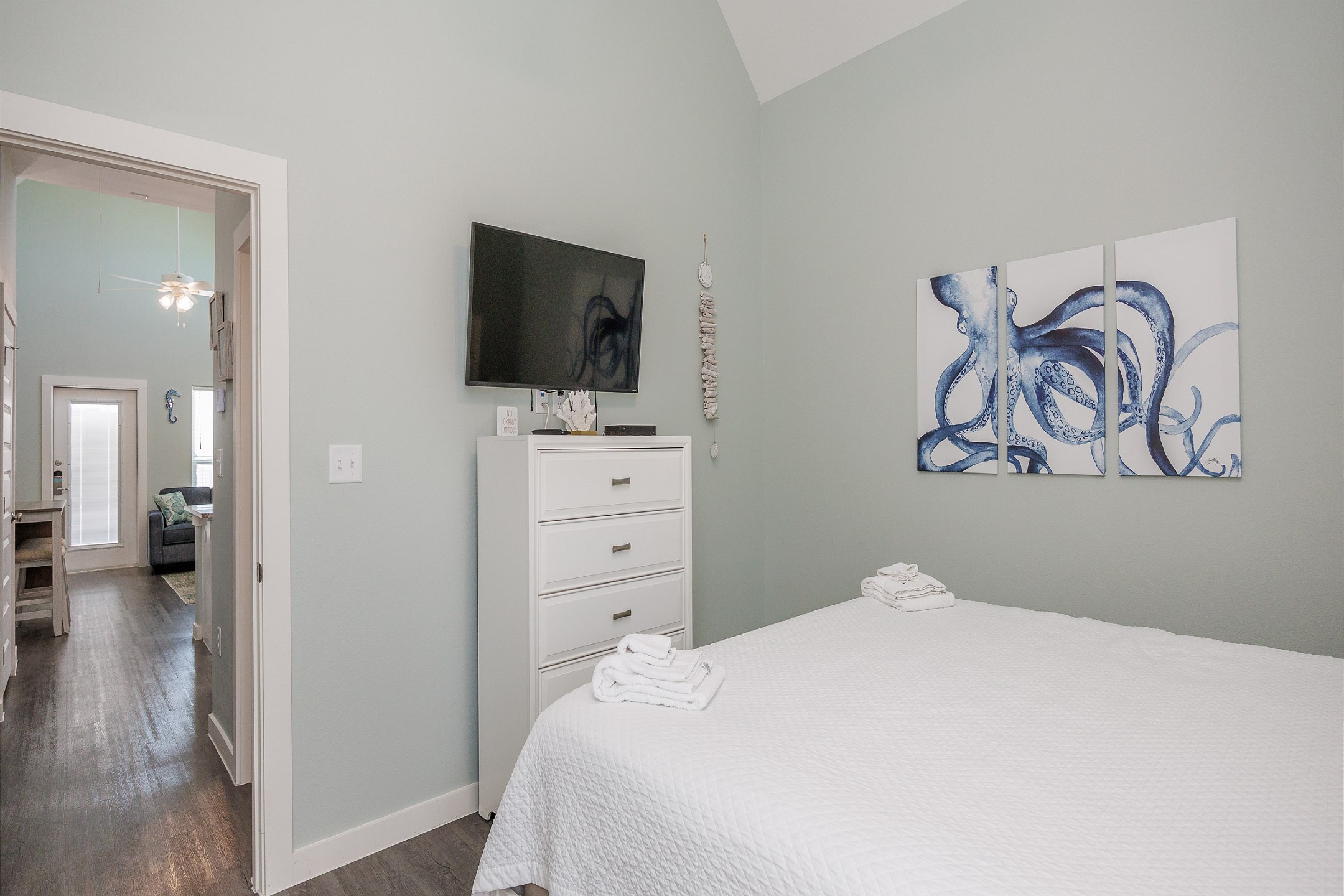 Master bedroom with king size bed, flat screen TV and access to the private patio