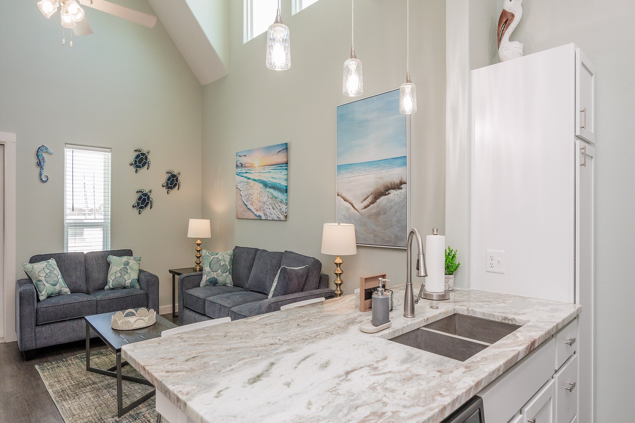 Kitchen space with beautiful counter tops, updated lighting and open to the living space