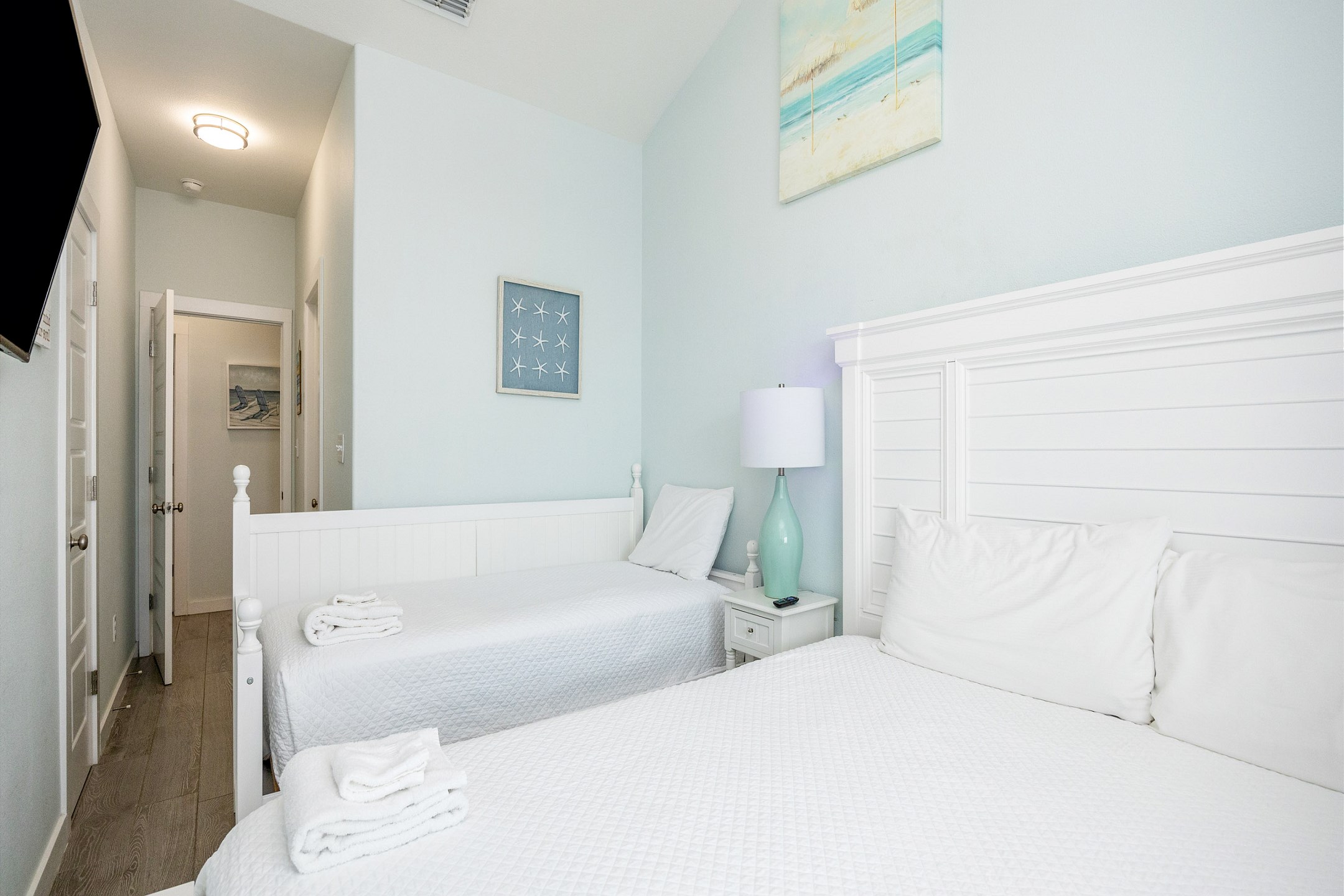 Second bedroom on the second floor with king size bed, twin size day bed with twin trundle, and a flat screen TV 