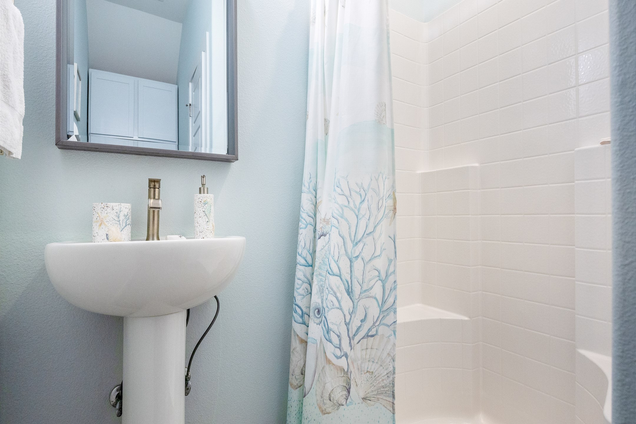 Guest bathroom on the first floor with sink, toilet and walk in shower 