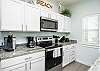 Bright kitchen area with plenty of counter space to prepare family dinners 