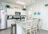 Beautiful modern kitchen area with bar stools, perfect for entertaining 