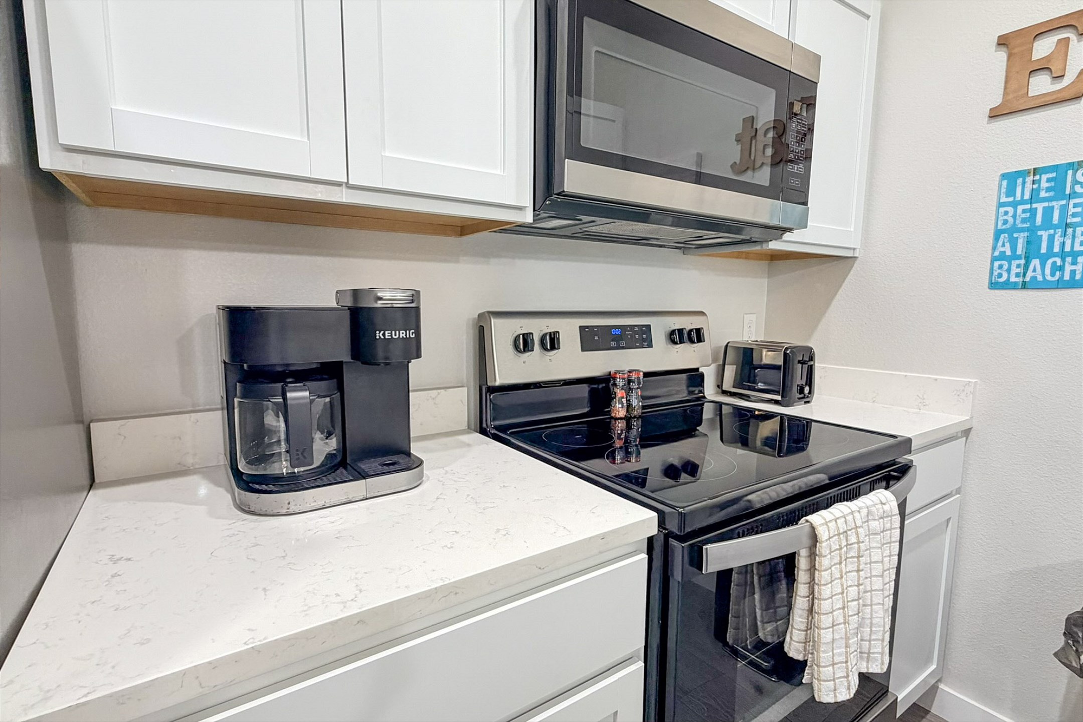 Coffee maker, toaster, and other essentials provided in this well-equipped kitchen