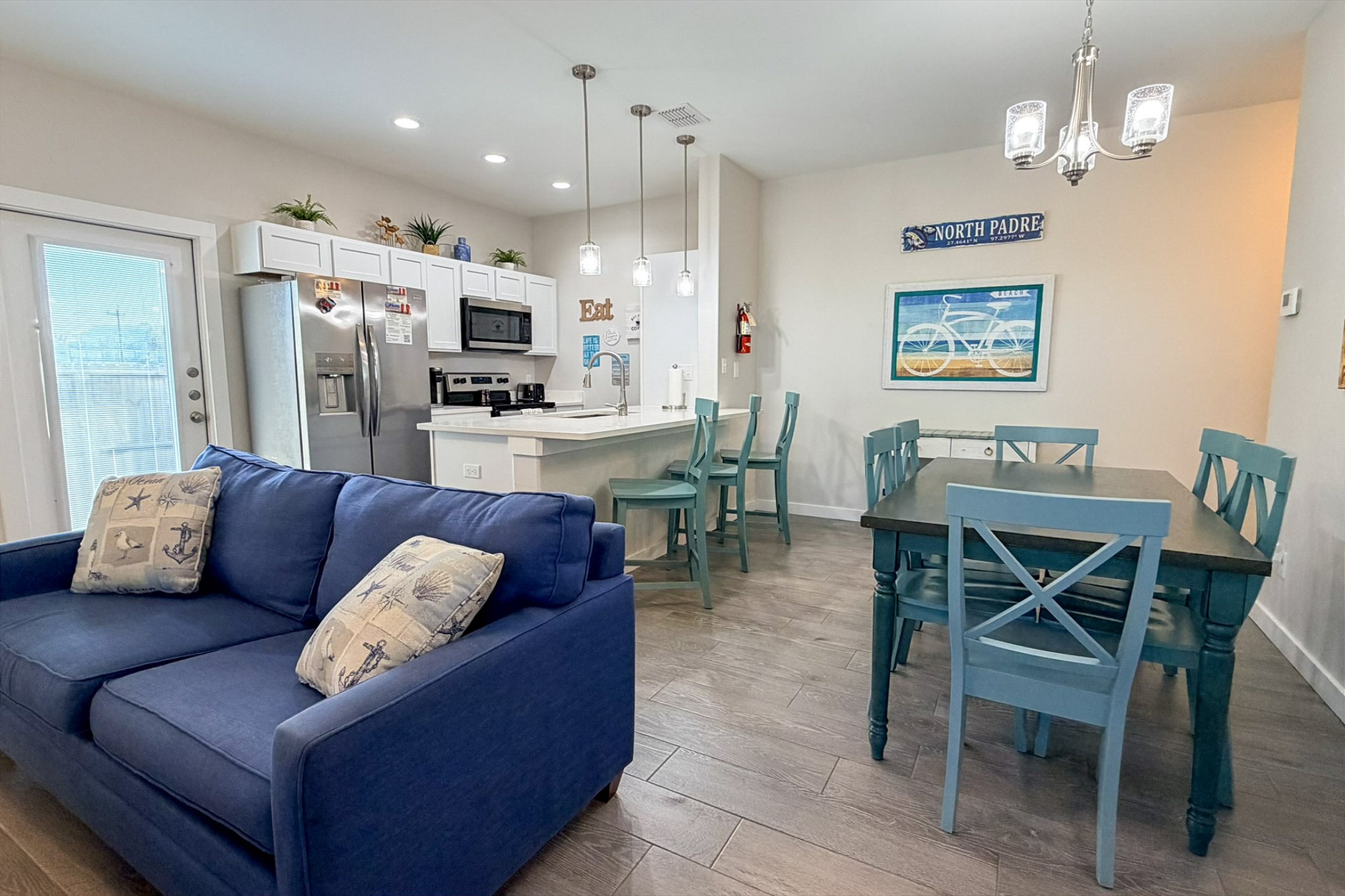 The kitchen, dining, and living areas blend seamlessly together for a bright and airy feel