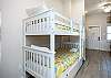 Twin size bunk beds and washer / dryer in hallway