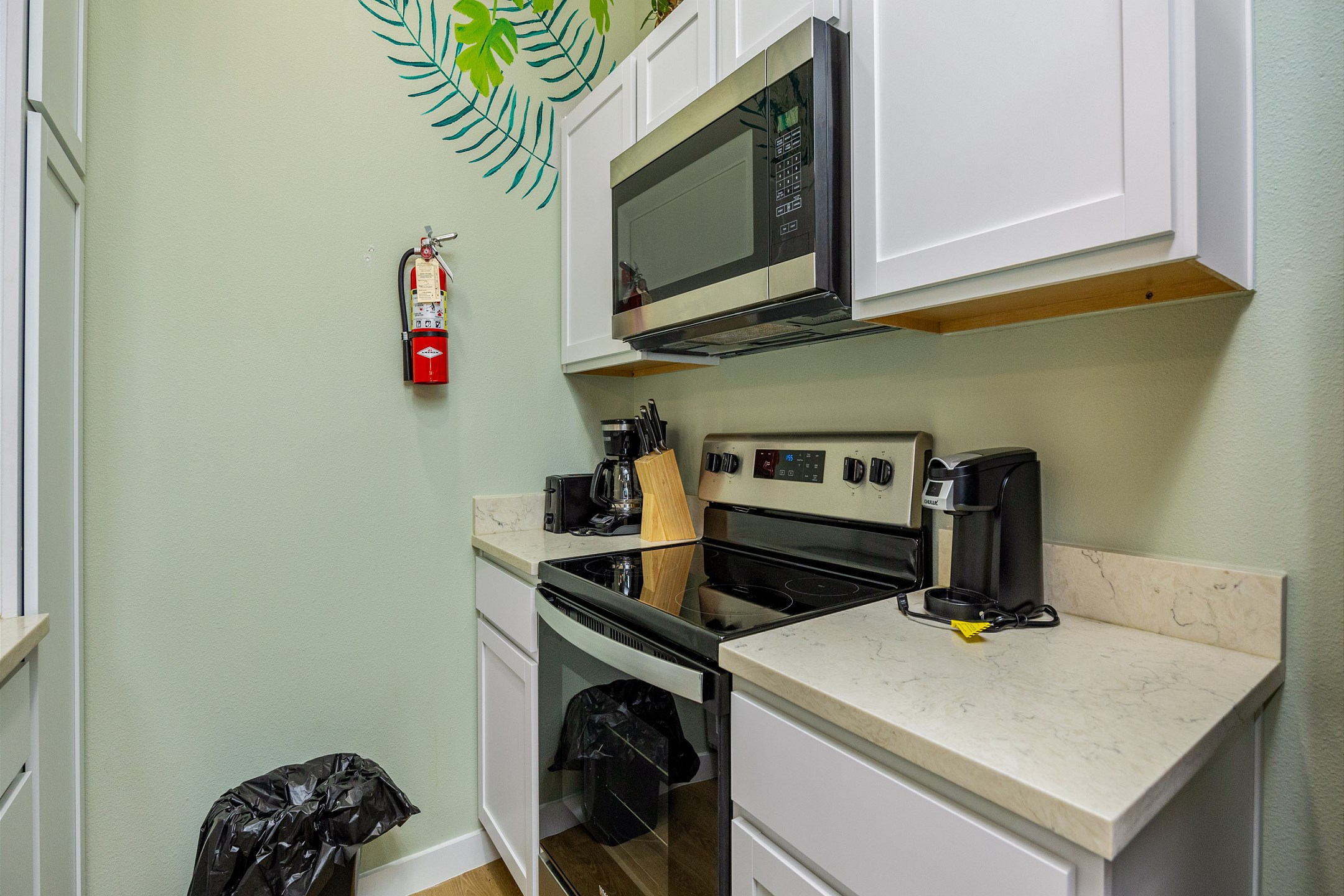 Coffee maker, toaster, cookware, dinnerware, and other kitchen essentials provided