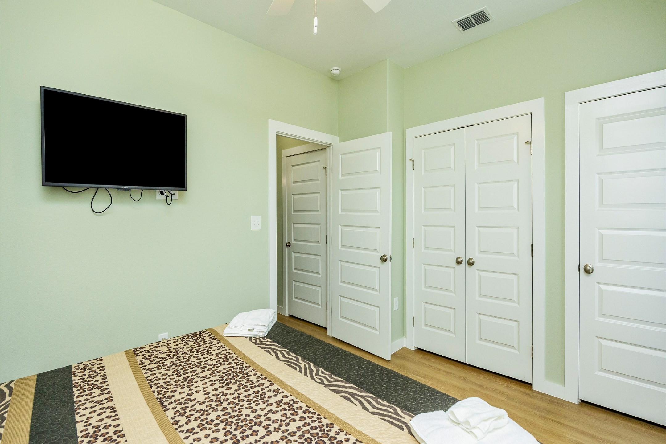 Master bedroom on the first floor with a king size bed, access to the private patio and flat screen TV