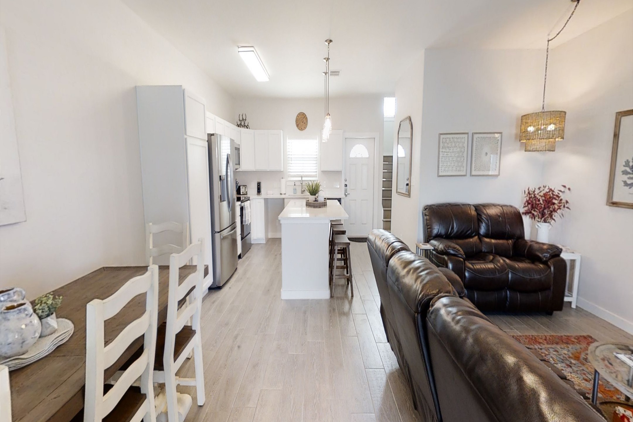 Experience the spacious and modern open-concept layout encompassing the living, dining, and kitchen areas, perfect for socializing and entertaining