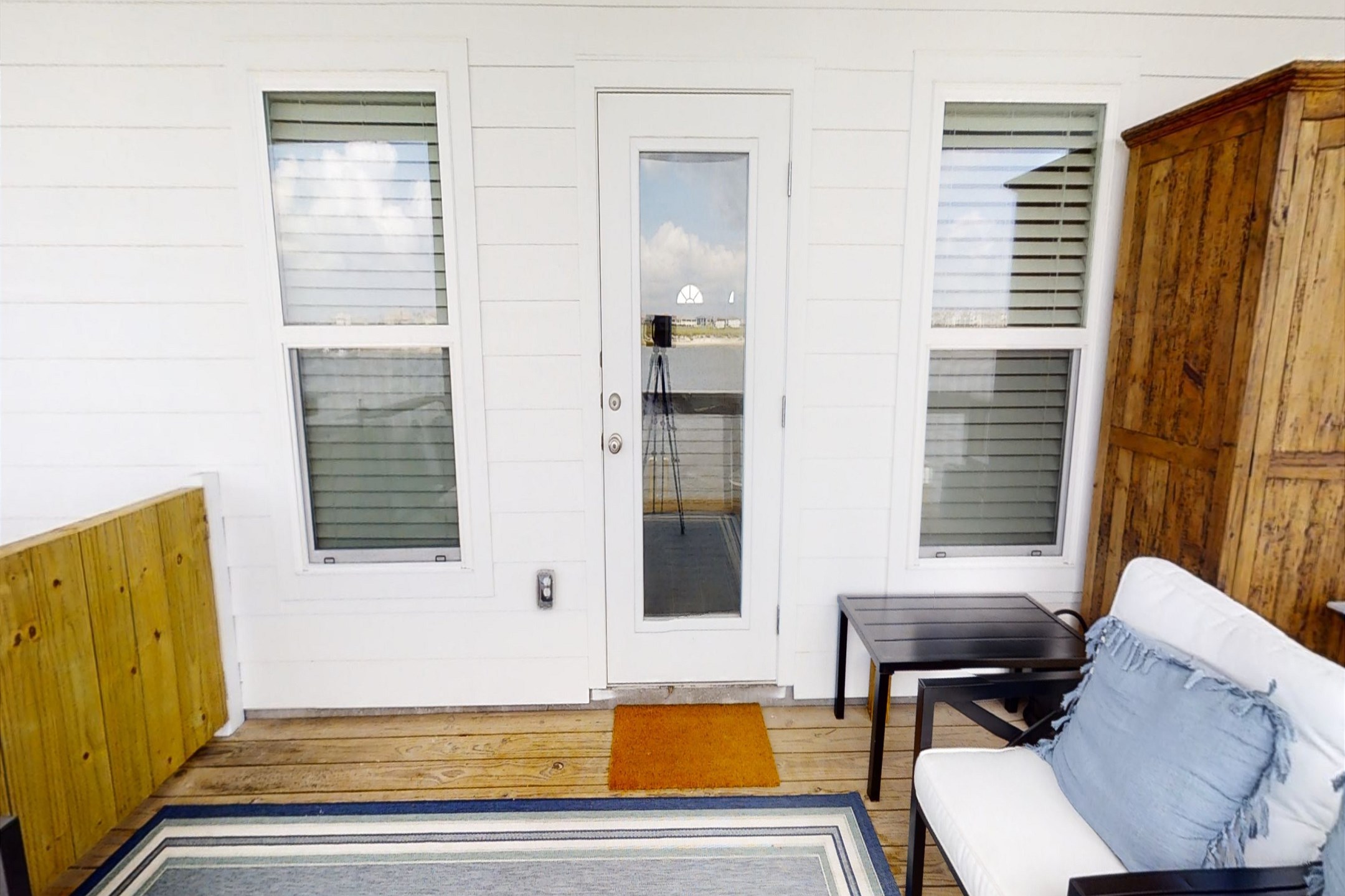 Unwind in the primary bedroom''s second-story balcony, boasting stunning water views and cozy seating for a serene and relaxing escape