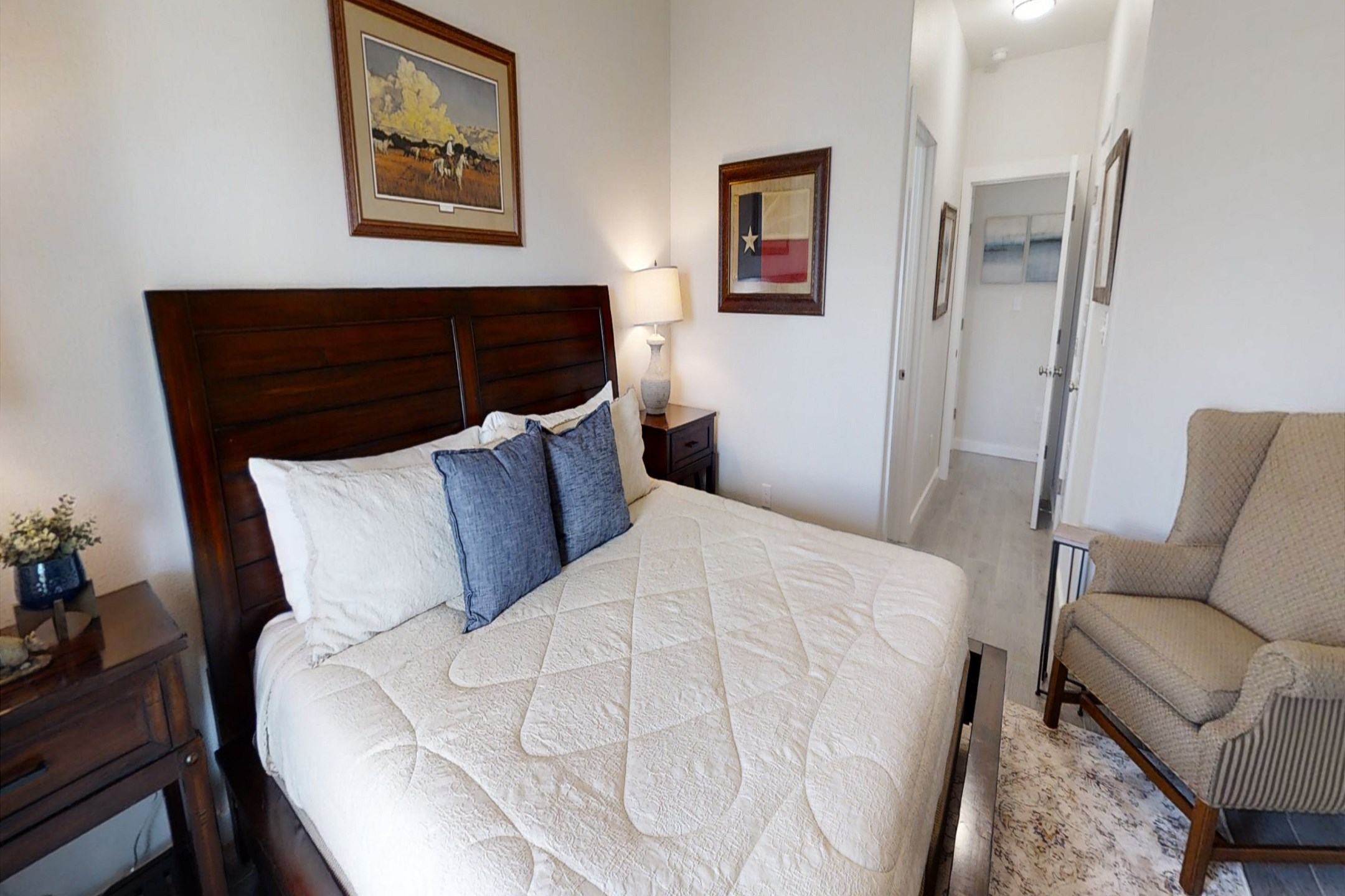 Master bedroom on the second floor with king size bed, private bathroom, flat screen TV, and back patio access 