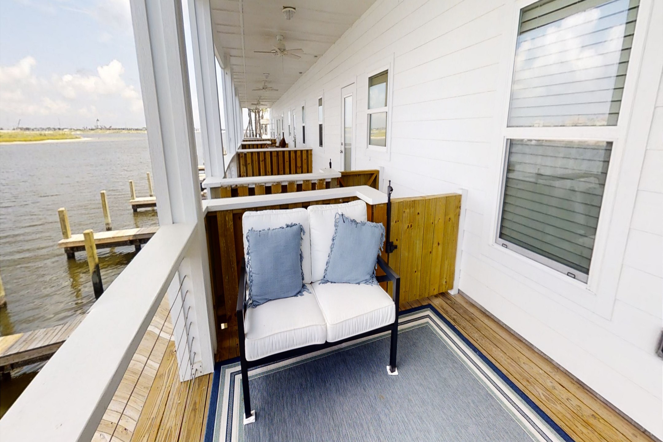 Unwind in the primary bedroom''s second-story balcony, boasting stunning water views and cozy seating for a serene and relaxing escape