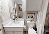 Enjoy the luxurious master bathroom complete with a single sink, toilet, and elegant walk-in shower 
