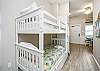Charming twin size bunk beds and washer / dryer in hallway