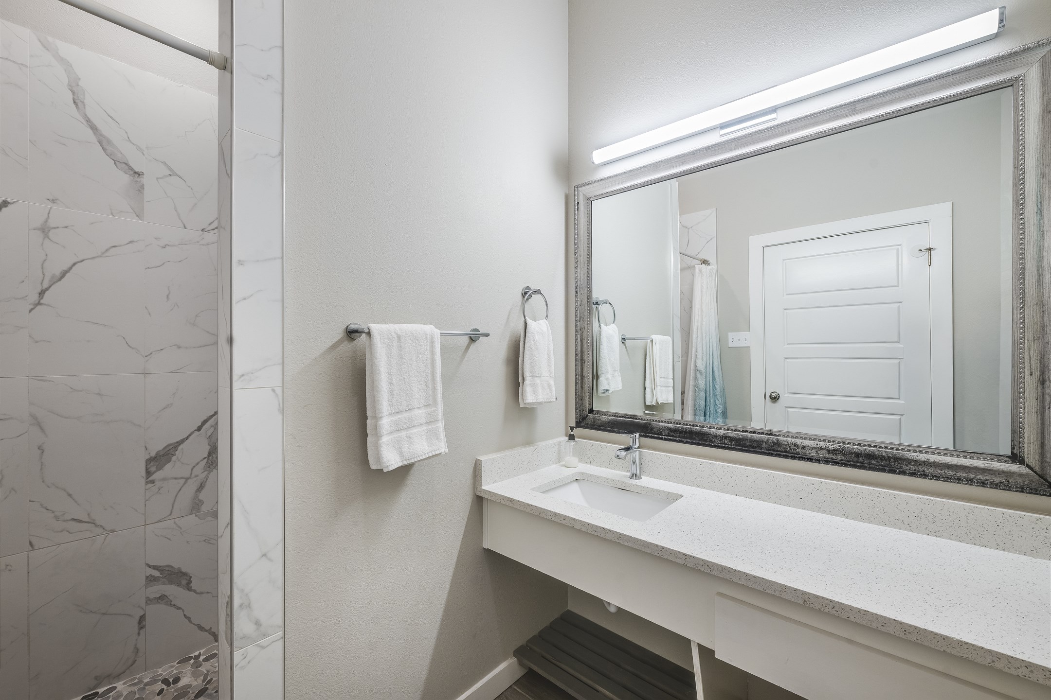 Full bathroom with sink, toilet, and walk-in shower