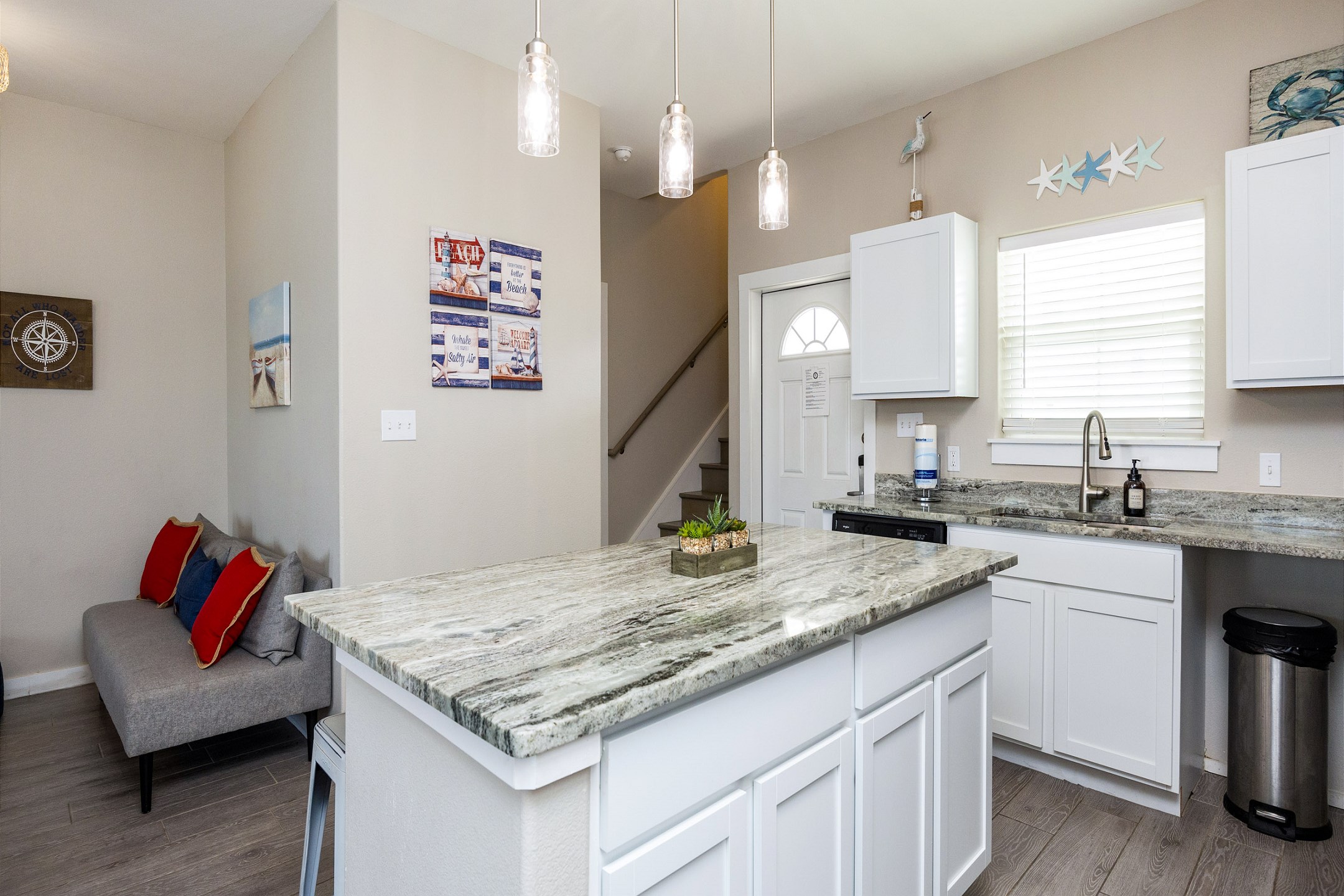 Well-lit kitchen island with farm house sink 