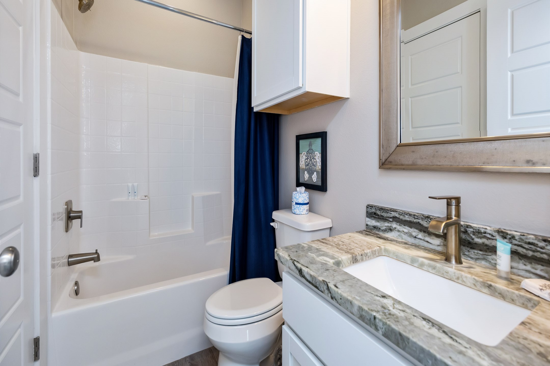Guest bathroom on the second floor with a sink and tub/shower combo 