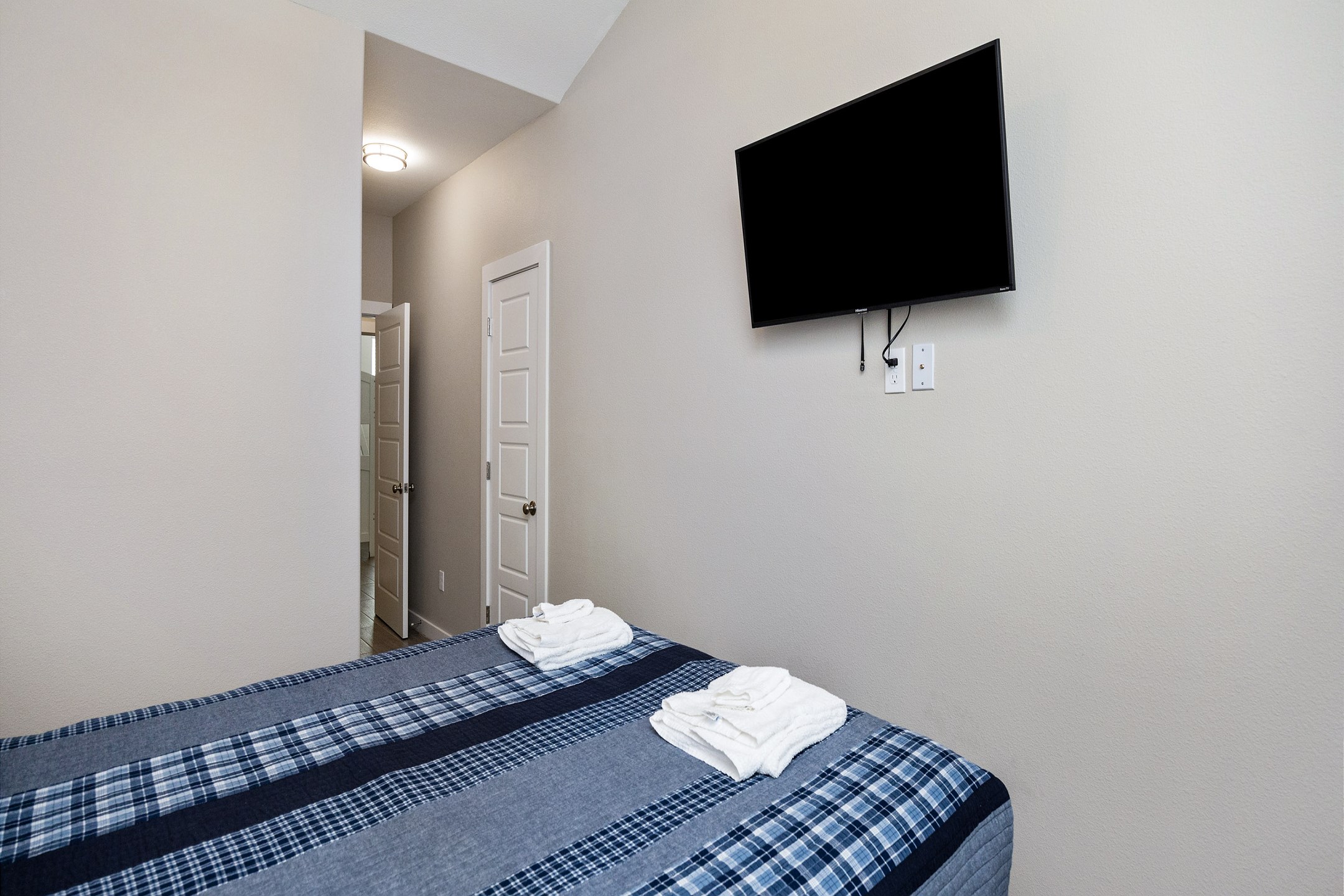 Second bedroom on the second floor with a full size bed and flat screen TV