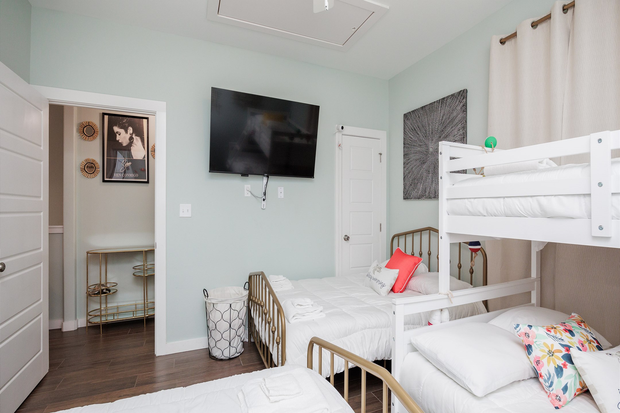 Second bedroom on the second floor with two full size beds, twin over full size bunk bed, and 55-inch flat screen TV