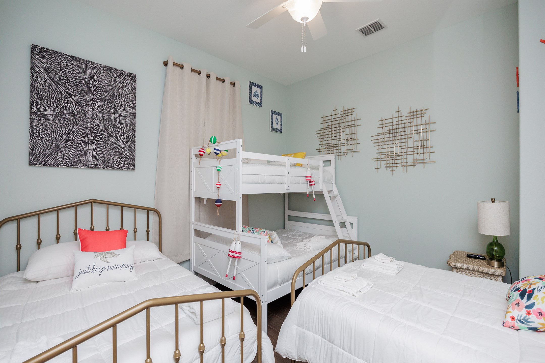 Second bedroom on the second floor with two full size beds, twin over full size bunk bed, and 55-inch flat screen TV