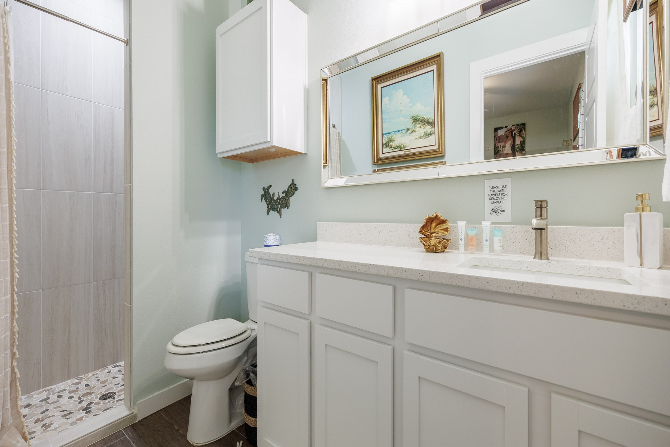 Master bathroom on the first floor with single sink and walk in shower