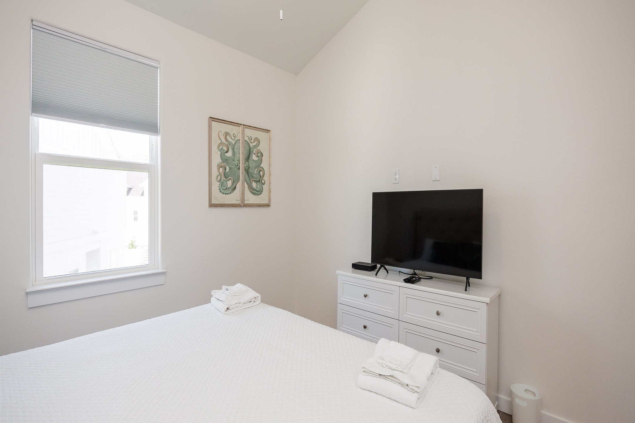 Master bedroom on the second floor with king size bed, private bathroom, and flat screen TV 