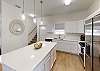 Kitchen area with beautiful white granite counter tops 