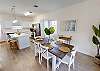 Dining area with seating for 6 that opens up into the kitchen and living area 