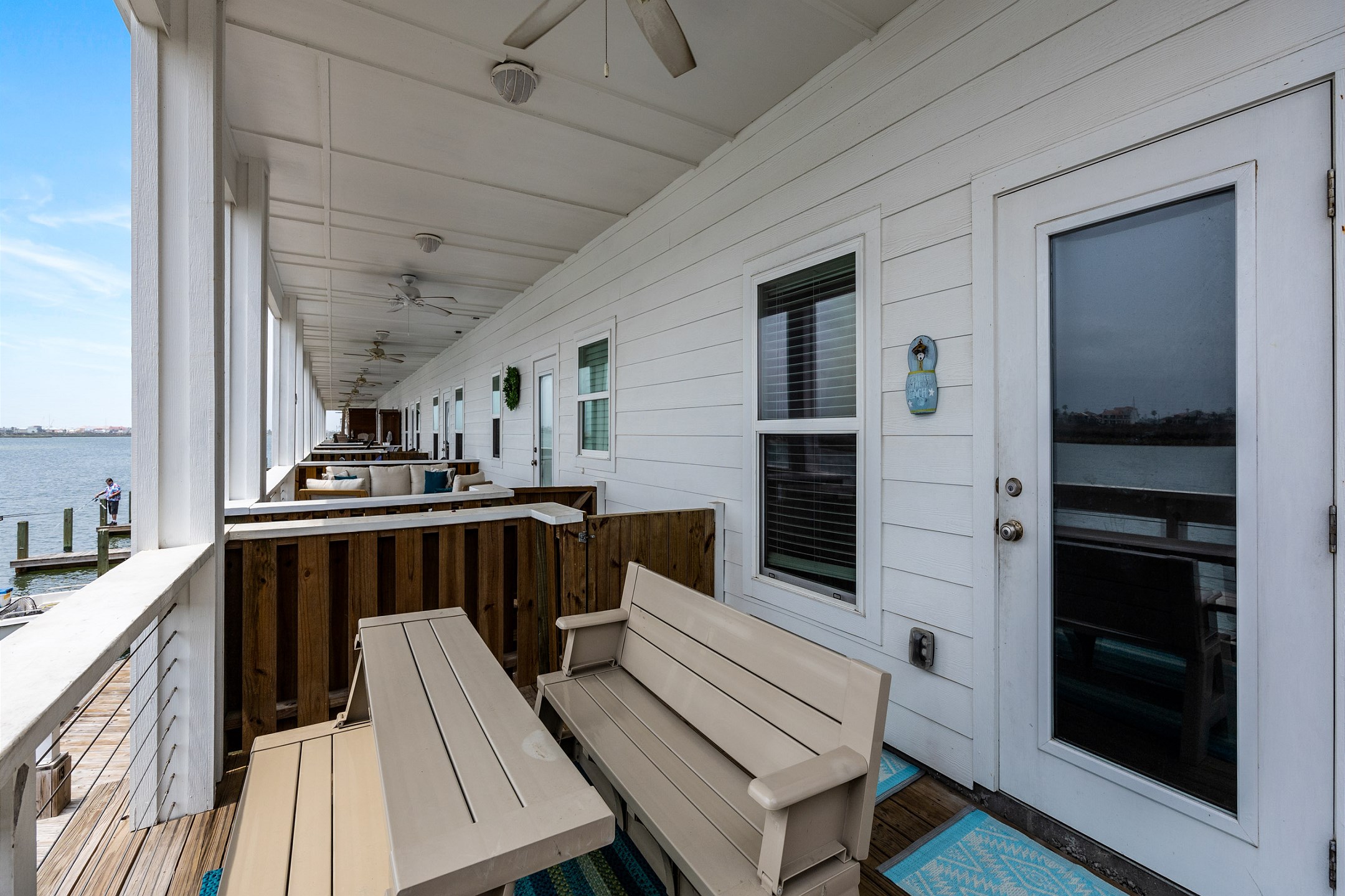 Beautiful balcony with water views and plenty of seating just off the kitchen, dining, and living area