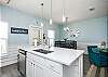 Bright kitchen Island with beautiful white counter tops 