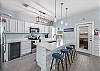 Beautiful modern kitchen area with bar stools for entertaining 