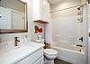 Guest bathroom on the second floor with single sink, along with tub and shower combo 