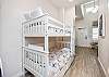 Twin size bunk beds and washer / dryer in hallway